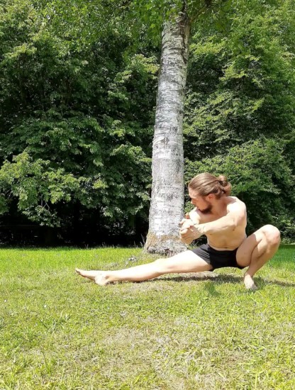 This image shows em doing a leg workout and performing a cossack squat.