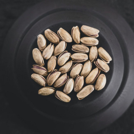 This image shows healthy fats in form of pistaccios in a bowl.